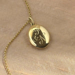 Solid yellow gold heirloom locket with traditional hand engraving of loved ones initials
