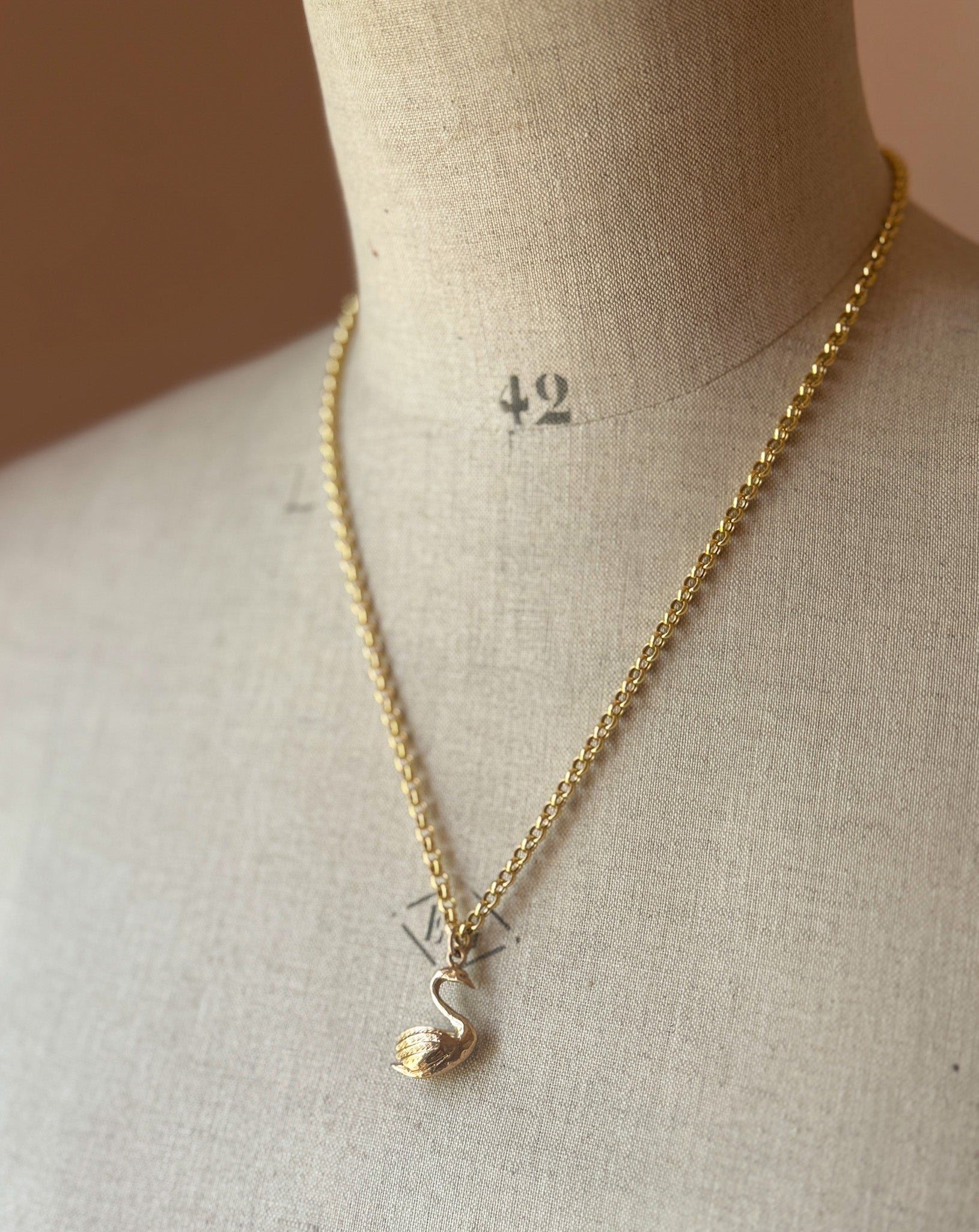 Gold necklace with a swan pendant