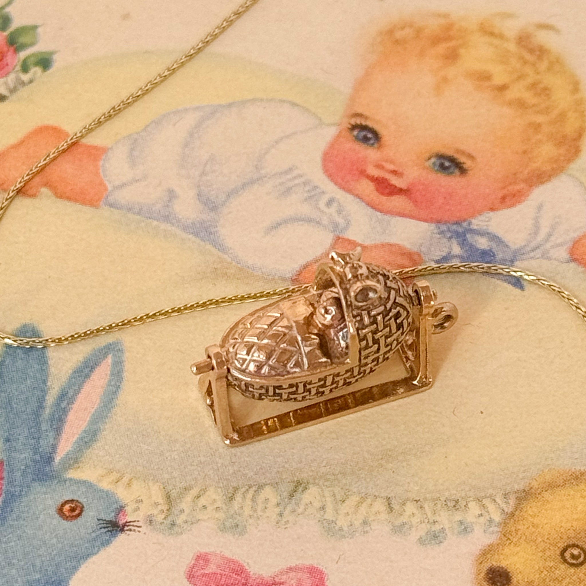 Vintage baby in a cot charm that rocks and spins 
