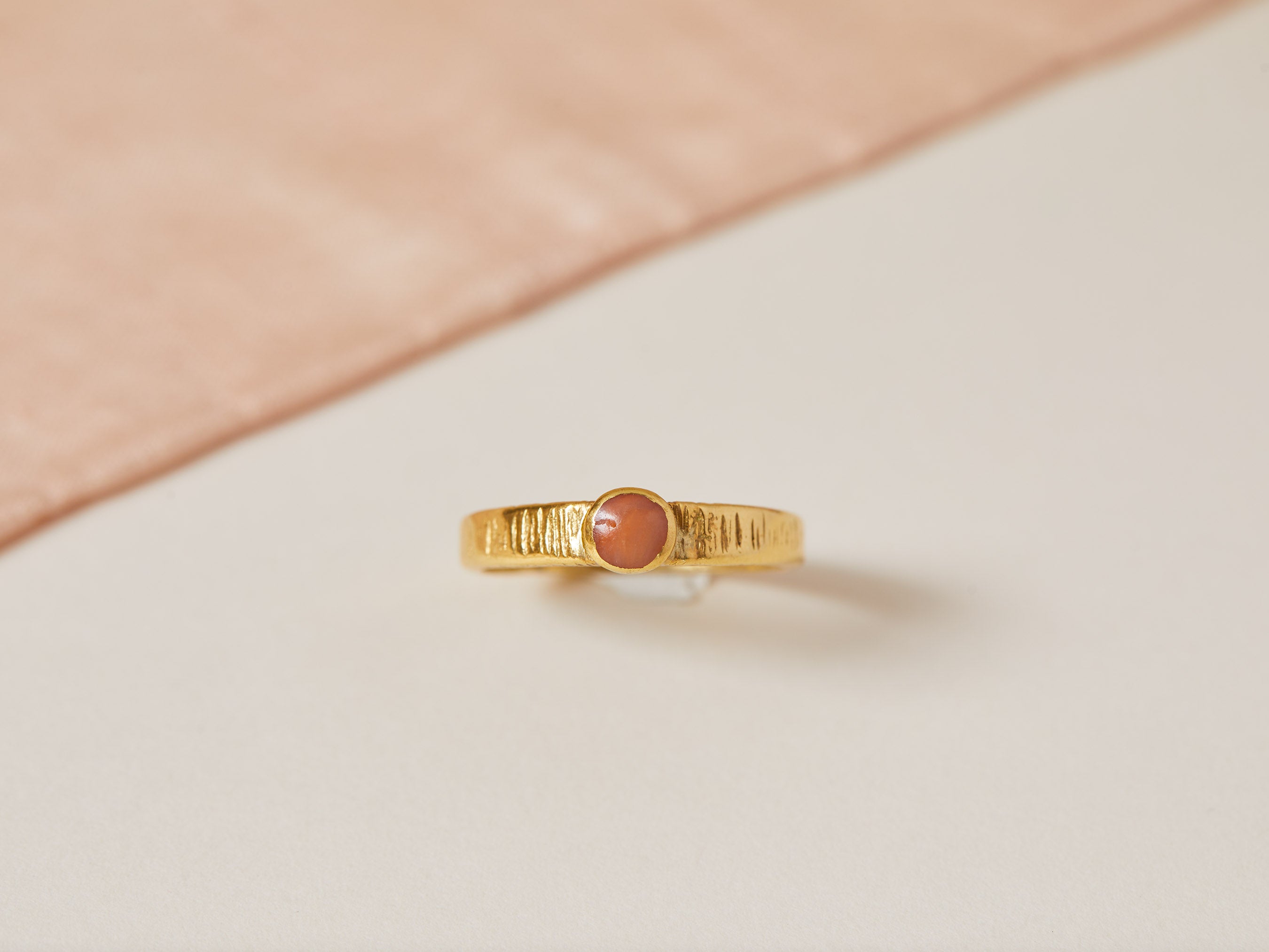 Coral rub over set stone ring 