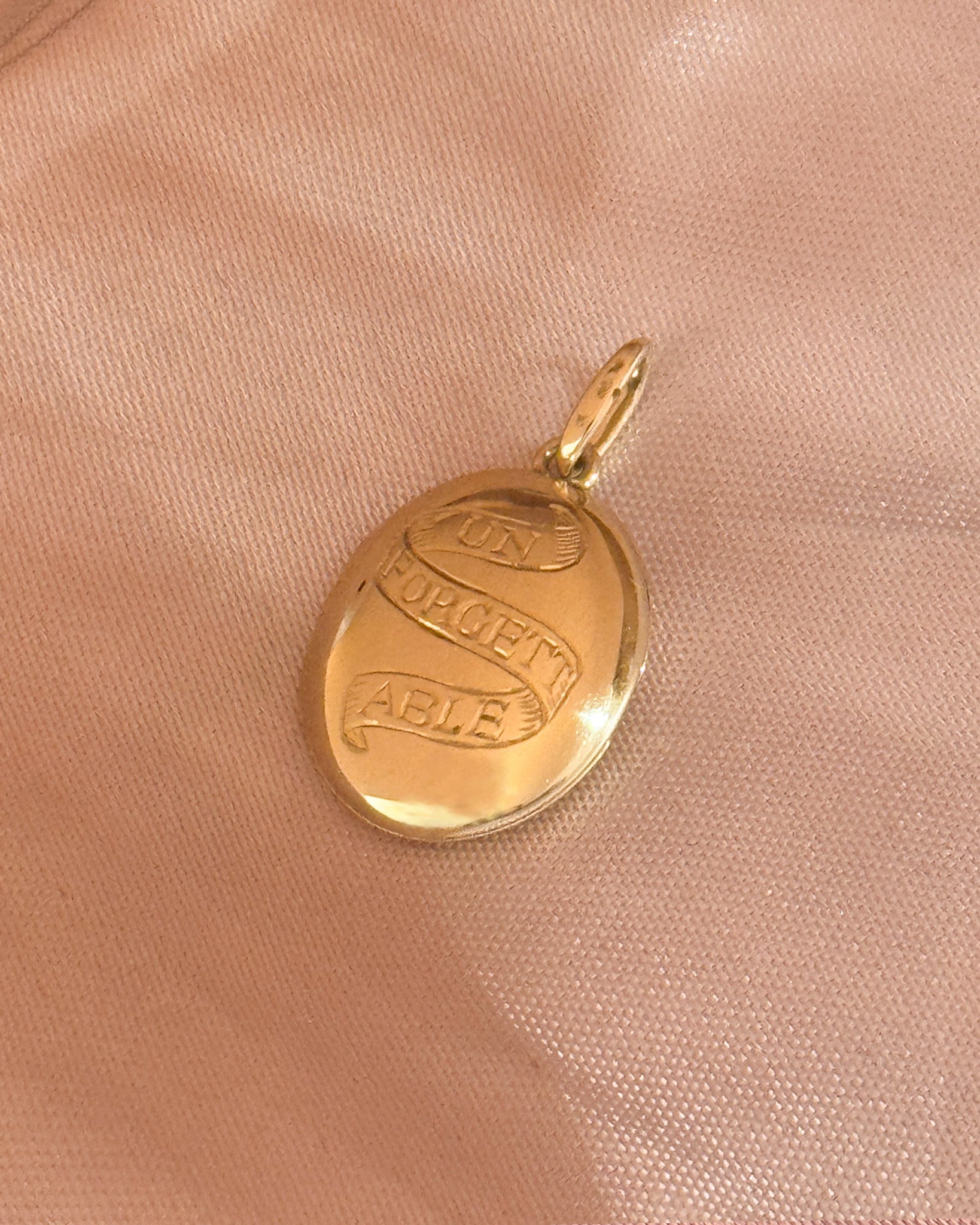 Solid gold locket with the words unforgettable engraved 