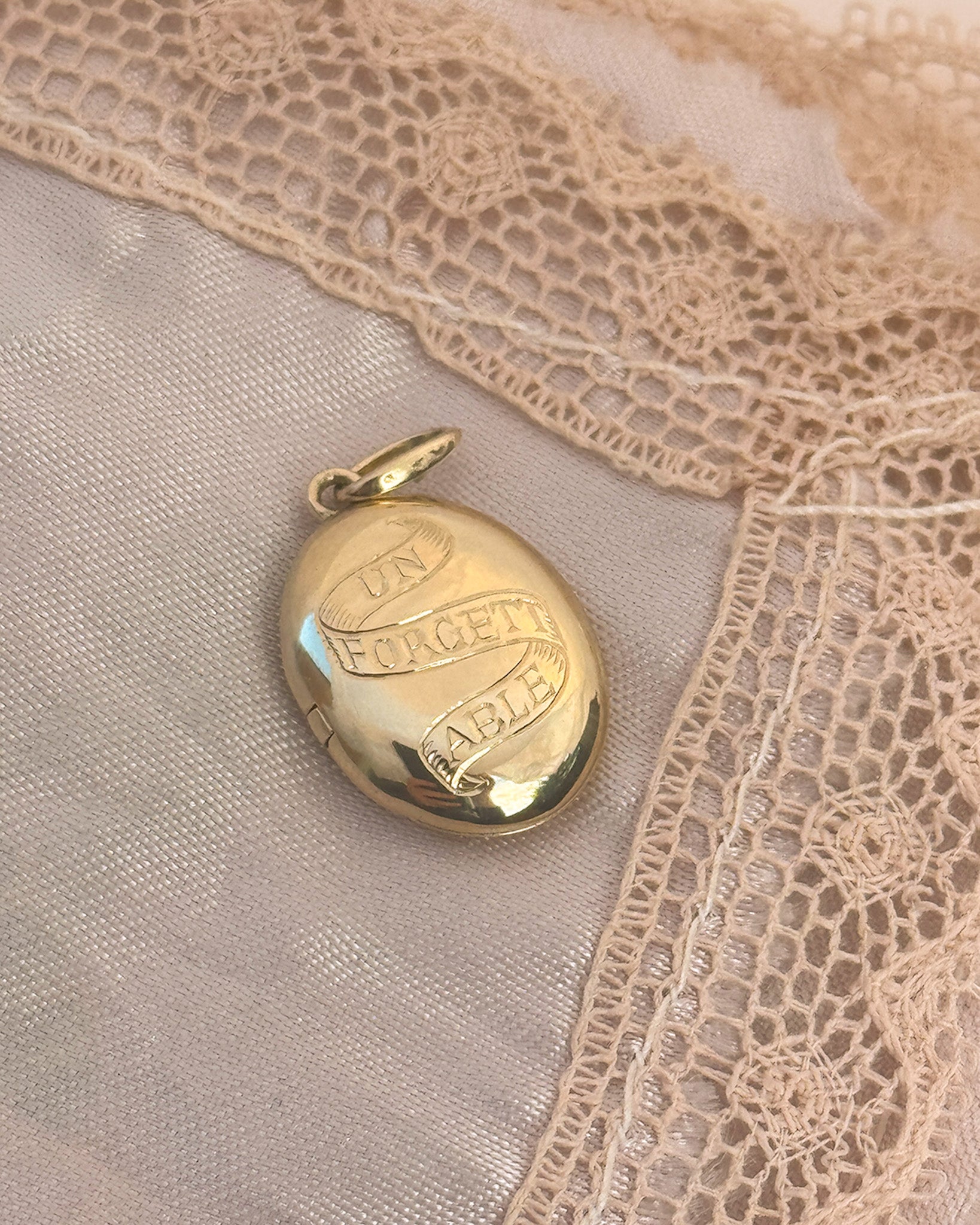 Antique inspired solid gold locket with the words unforgettable traditionally engraved 