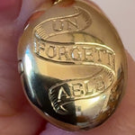 Solid gold locket showing the beautiful close up details of hand engraving 